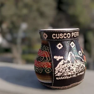 clay cup lined with Andean textiles from Cusco and leather engraved with an image of Machu Picchu (“Wonder of the World”)